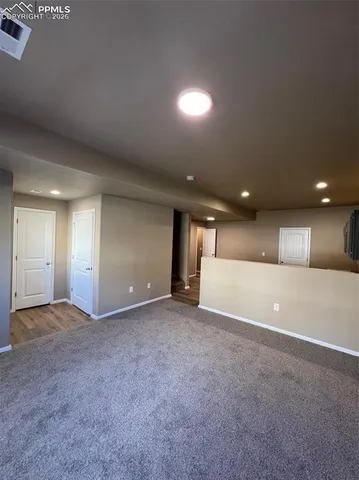 an empty room with a empty space and windows