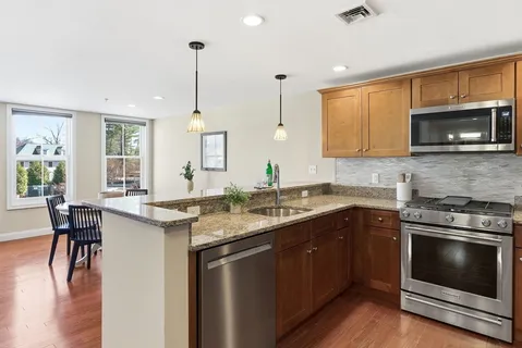 a kitchen with a stove sink and microwave