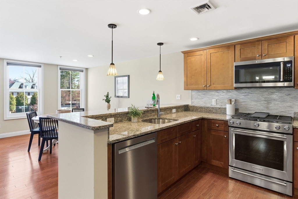 70 Great Road, Unit G Bedford, MA 01730 - Photo 2 of 15 a kitchen with a stove sink and microwave