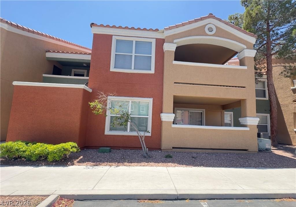 8101 West Flamingo Road, Unit 1082 Las Vegas, NV 89147 - Photo 2 of 23 Multi-level residential facade featuring arched balconies and stucco finishes.