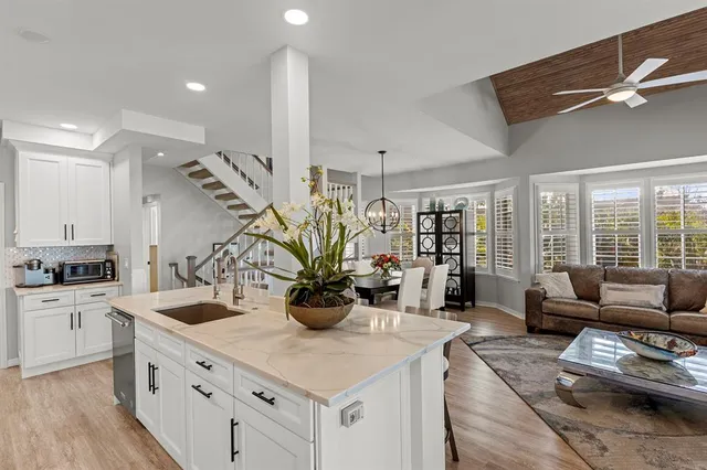 a kitchen with a stove a sink and a refrigerator