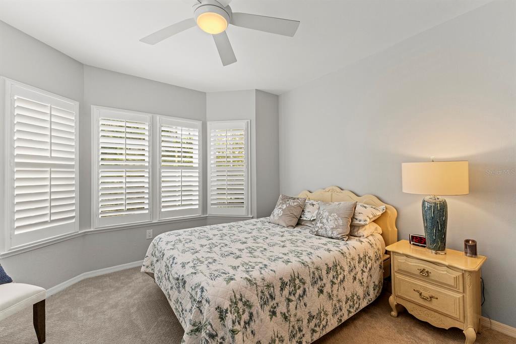 17 Seawatch Drive Boca Grande, FL 33921 - Photo 23 of 47 a bedroom with a bed and a lamp