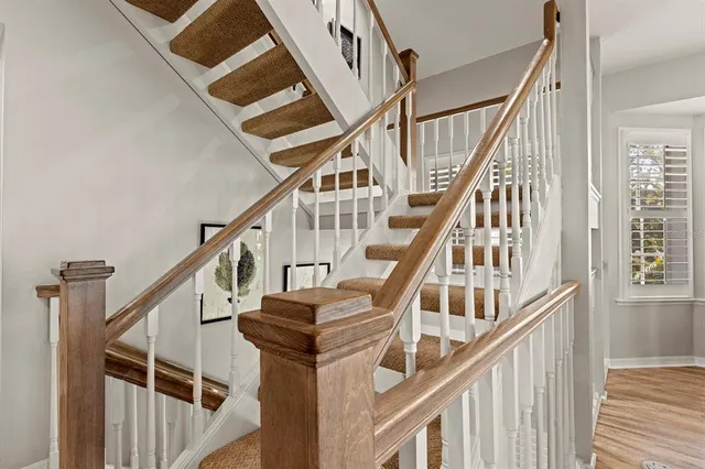 a bathroom with a sink a toilet a mirror and shower