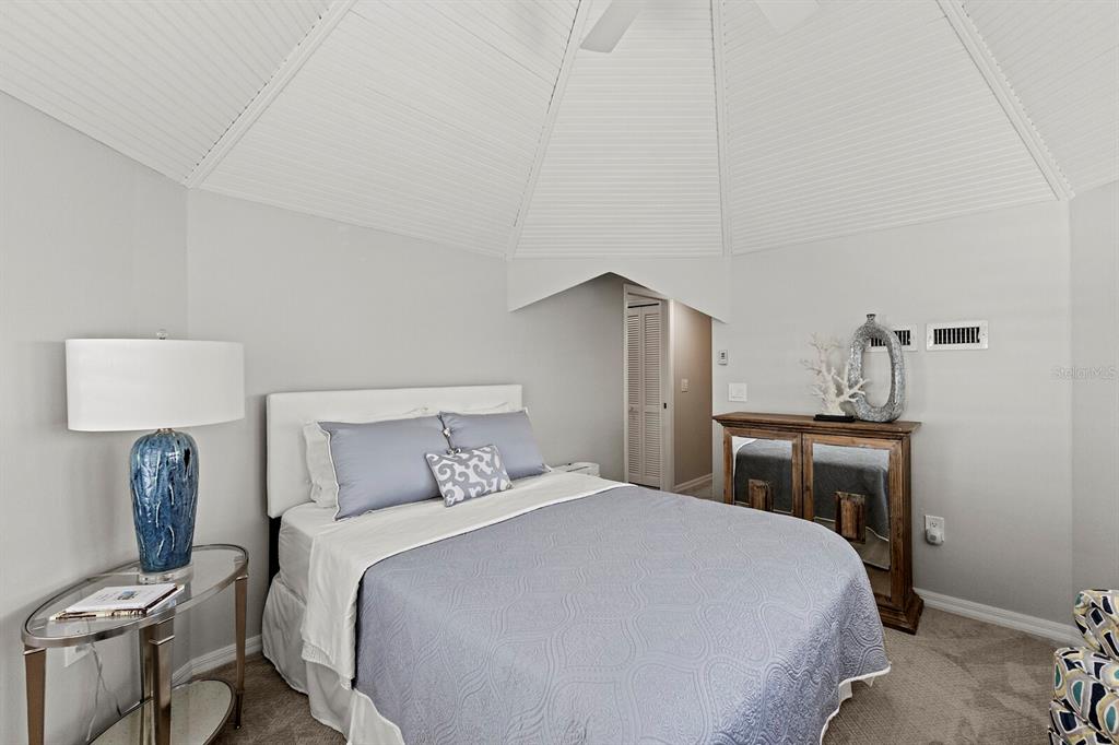 17 Seawatch Drive Boca Grande, FL 33921 - Photo 35 of 47 a bedroom with a bed and a table in it