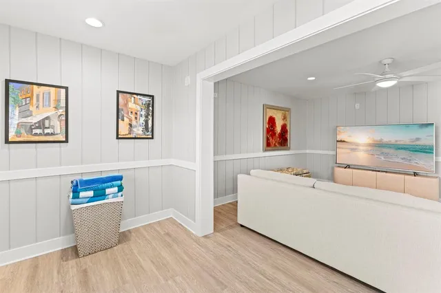 a living room with furniture and a kitchen view