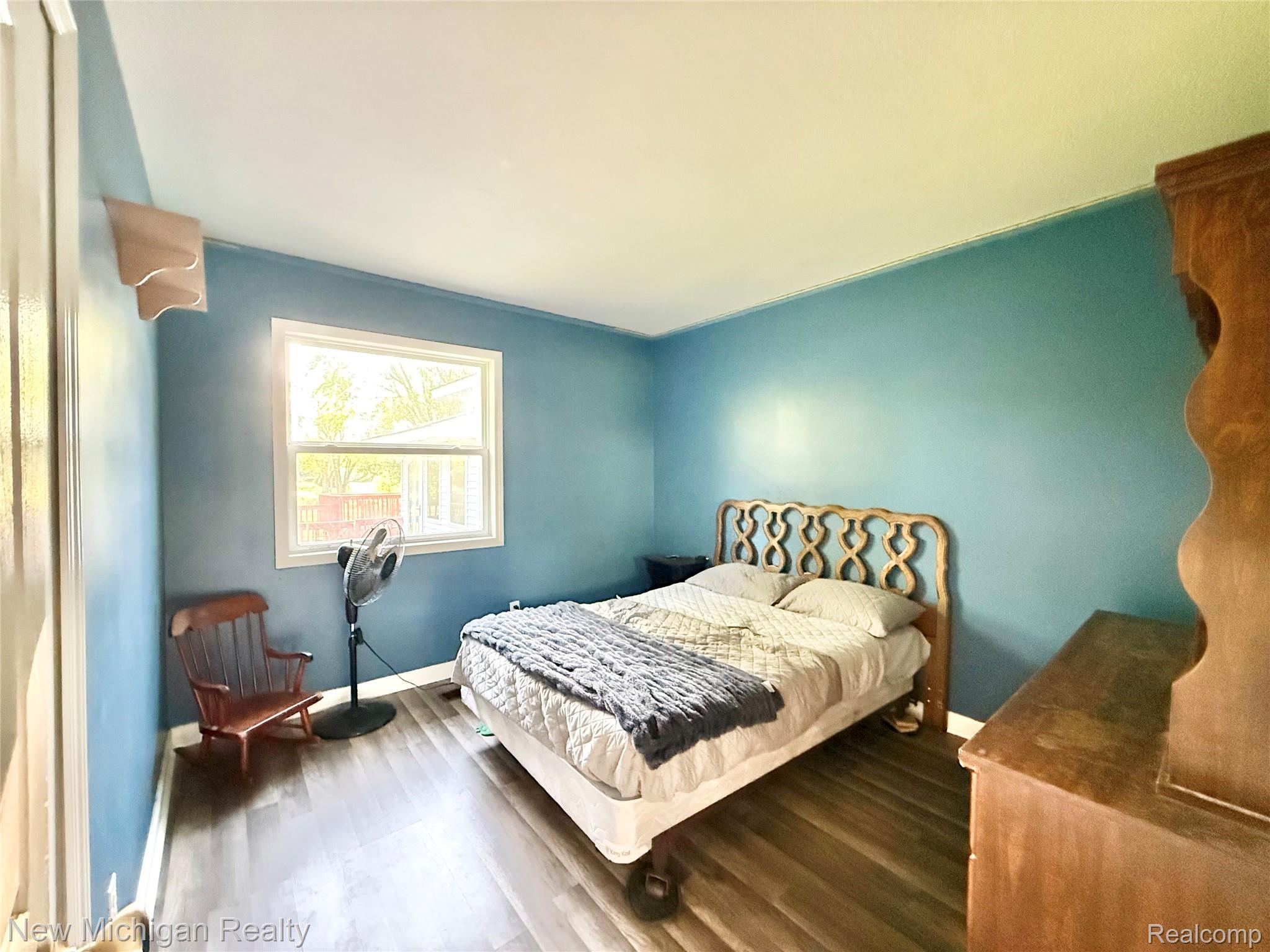 5288 Torrey Road Flint, MI 48507 - Photo 19 of 41 Bedroom featuring wood finished floors and baseboards
