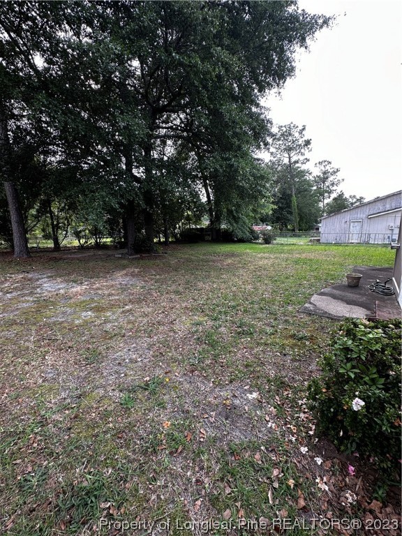 208 Duncan Road Spring Lake, NC 28390 - Photo 14 of 17 a view of outdoor space with green field and trees
