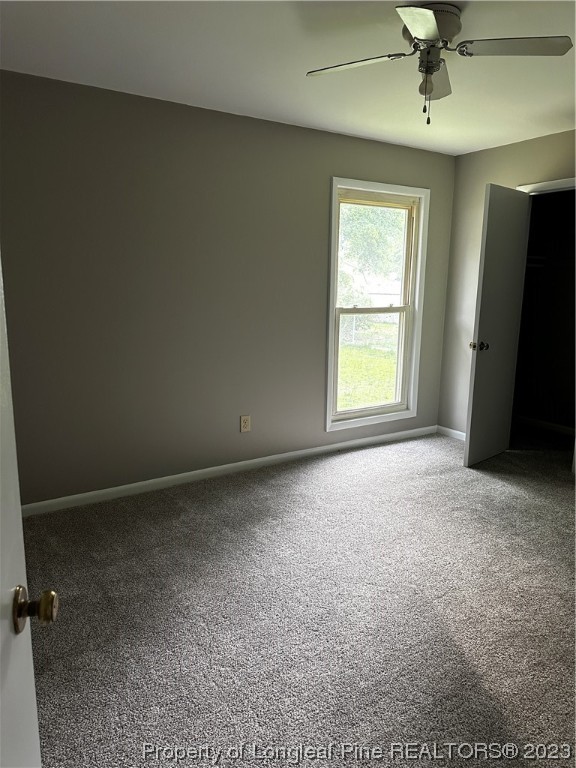 208 Duncan Road Spring Lake, NC 28390 - Photo 3 of 17 an empty room with windows and closet
