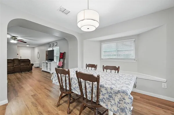 a view of a dining room with furniture and wooden floor