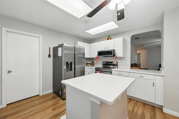 a kitchen with stainless steel appliances a refrigerator and a stove top oven