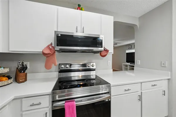 a kitchen with a stove and a microwave