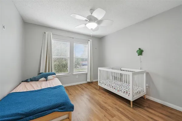 a living room with baby crib and a window