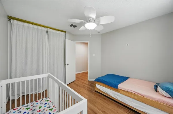 a bedroom with furniture and wooden floor