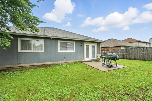 a view of a house with a yard and sitting area