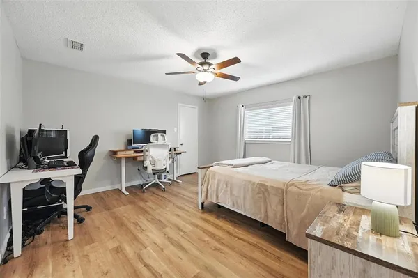 a bedroom that has a bed and a chair in it