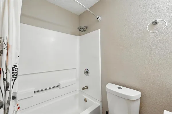 a bathroom with a shower a toilet and a sink