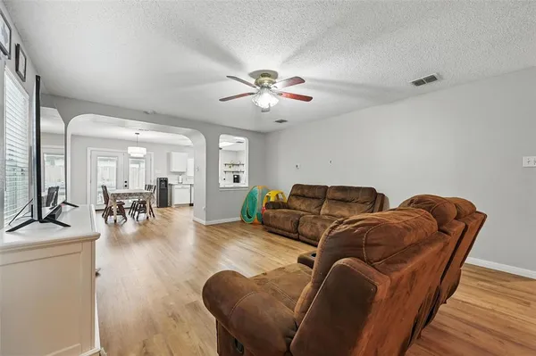 a living room with furniture and wooden floor