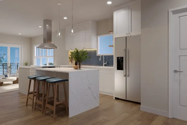 a kitchen with kitchen island granite countertop a table chairs refrigerator and microwave