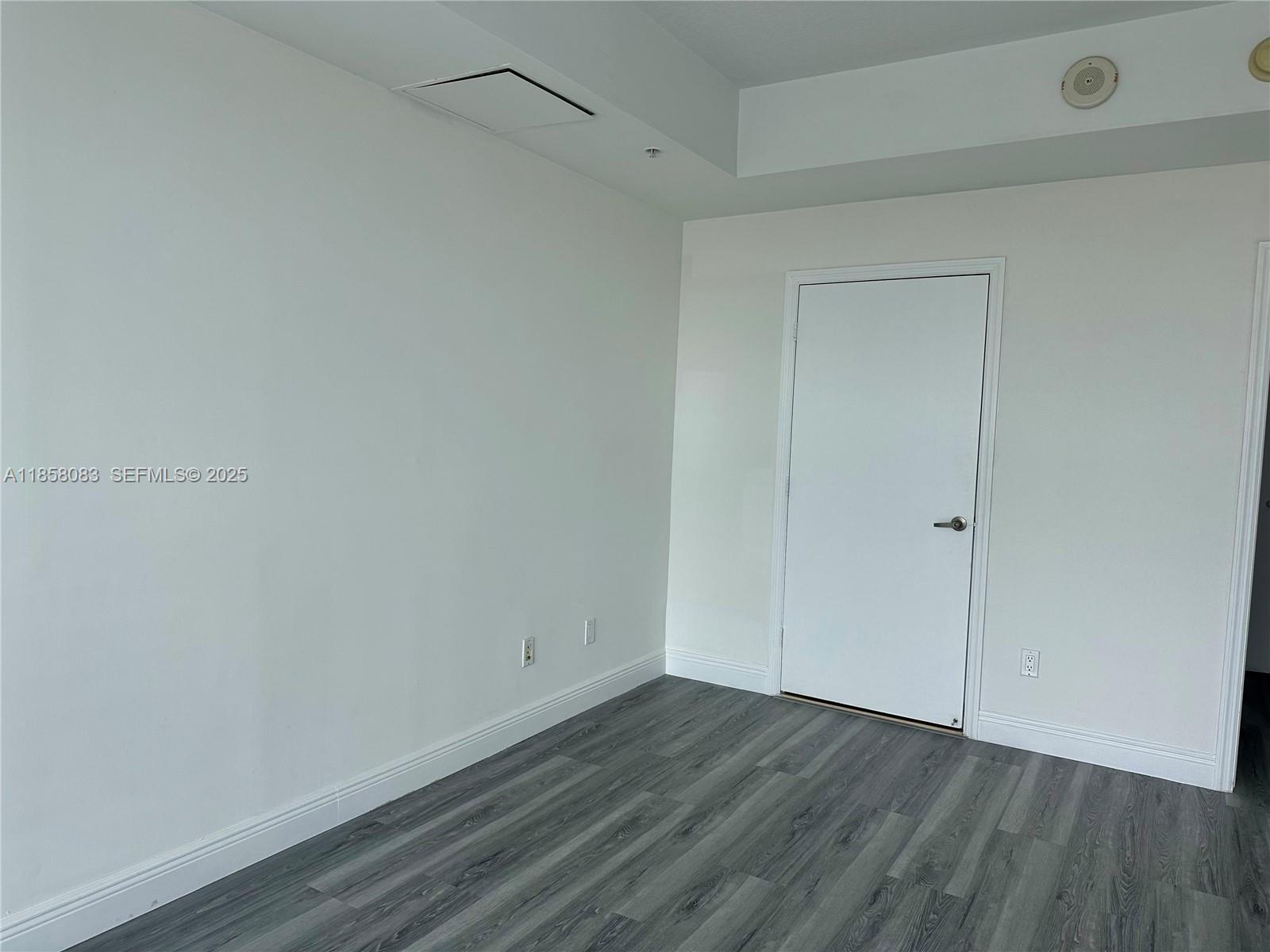 60 Southwest 13th Street, Unit 3207 Miami, FL 33130 - Photo 14 of 30 a view of an empty room with wooden floor