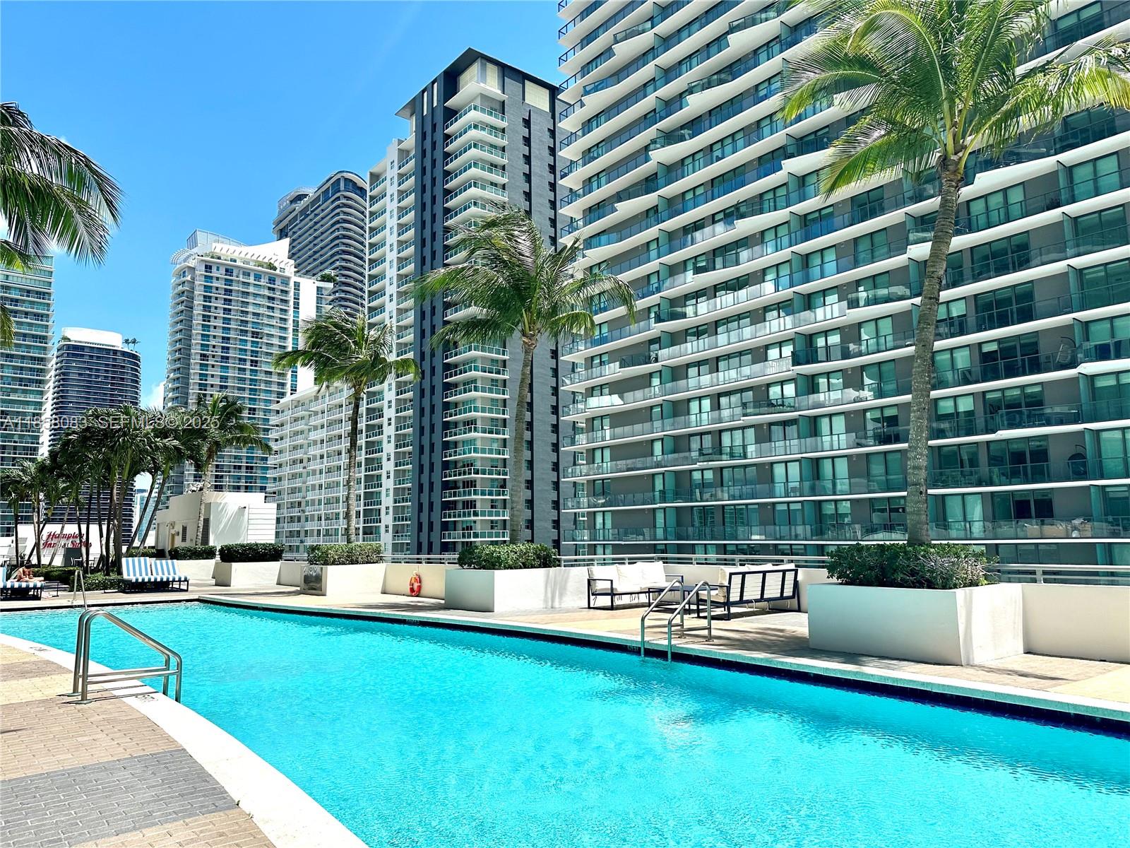 60 Southwest 13th Street, Unit 3207 Miami, FL 33130 - Photo 24 of 30 a view of a swimming pool with a lounge chairs