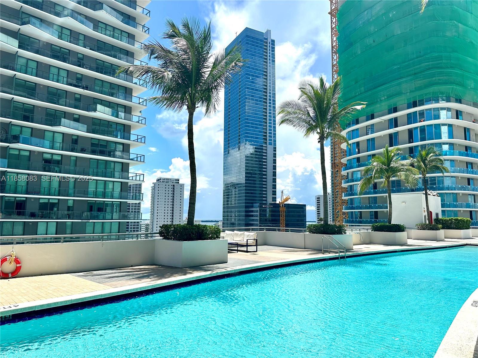 60 Southwest 13th Street, Unit 3207 Miami, FL 33130 - Photo 25 of 30 a swimming pool with outdoor seating and yard