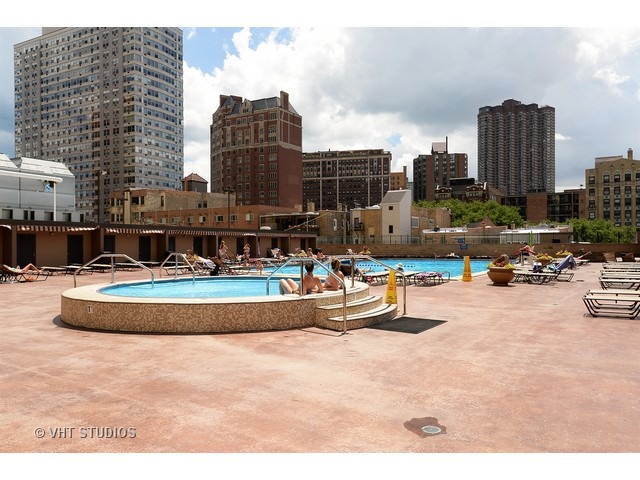 655 West Irving Park Road, Unit 1515 Chicago, IL 60613 - Photo 5 of 10 a swimming pool with outdoor seating and city view