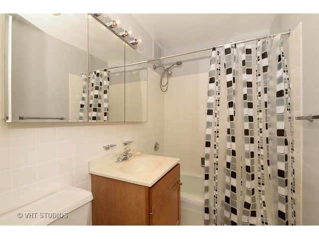 655 West Irving Park Road, Unit 1515 Chicago, IL 60613 - Photo 7 of 10 a bathroom with a sink toilet and shower
