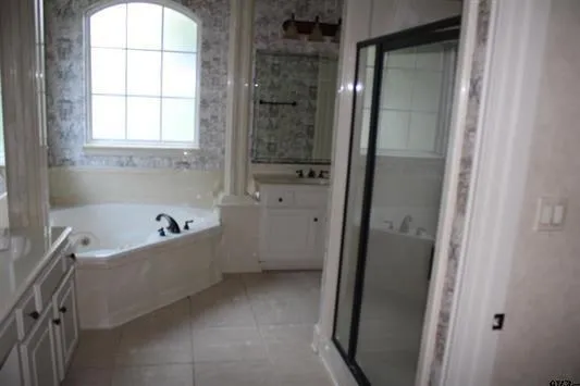 a bathroom with a bathtub and a shower