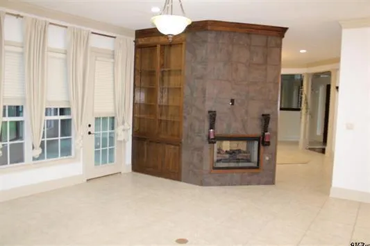 a view of a hallway with wooden floor and entryway