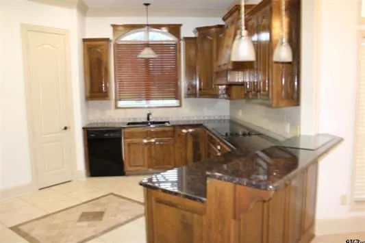 a kitchen with granite countertop a sink and a stove