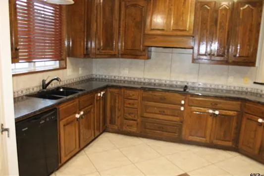 a kitchen with granite countertop a sink and cabinets