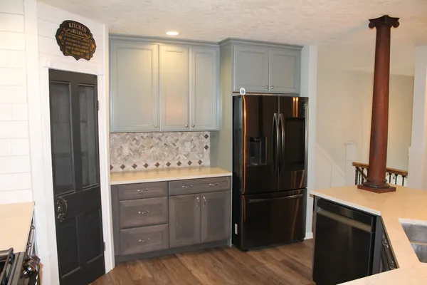 a kitchen with a refrigerator and a sink
