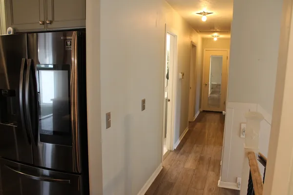 a view of a hallway with wooden floor