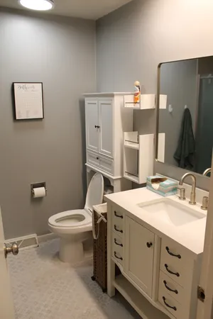 a bathroom with a sink toilet and mirror