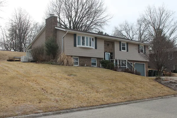 a house that has a tree in front of it