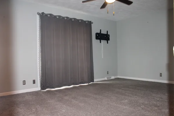 a bathroom with a shower a toilet and a sink
