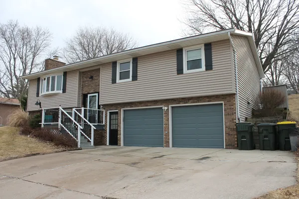 a front view of a house with parking area and parking