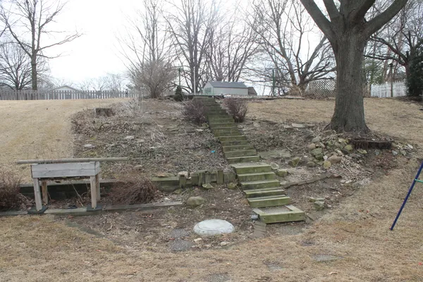 a backyard of a house with large trees