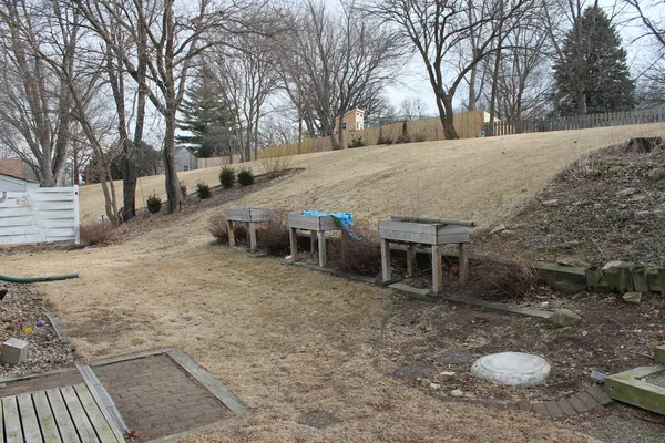 a backyard of a house with table and chairs