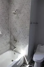 an empty room with wooden floor and a window