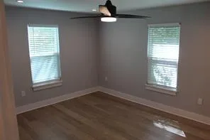 a view of a hallway with a chandelier fan