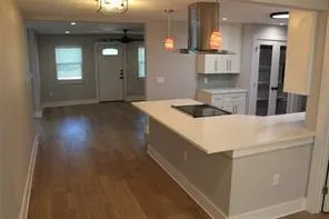 a kitchen that has a sink a stove and window