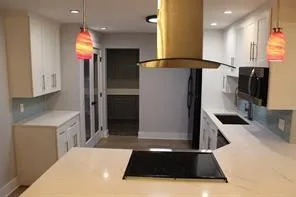 a kitchen with stainless steel appliances a refrigerator sink and microwave