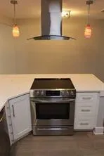 a stove top oven sitting inside of a kitchen