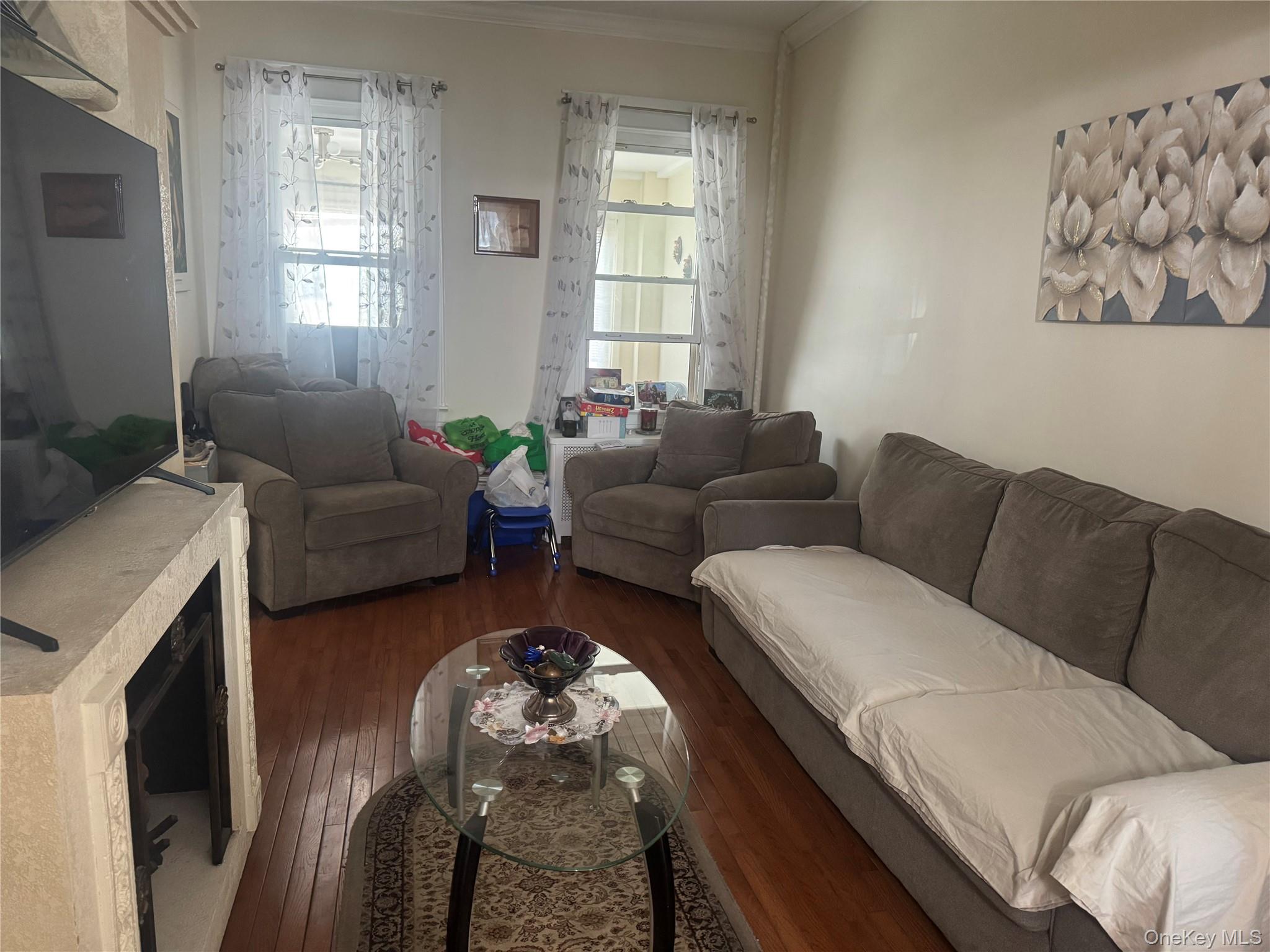 80-58 88th Road Queens, NY 11421 - Photo 4 of 21 a living room with furniture and a window