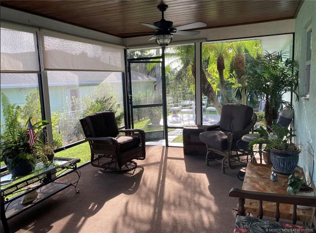 4621 Southeast Shady Ridge Lane Stuart, FL 34997 - Photo 10 of 11 a living room with furniture and a large window