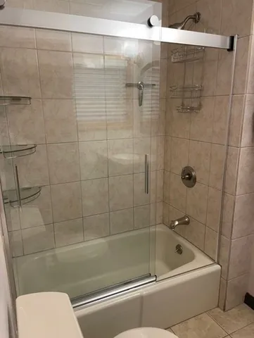 a bathroom with a shower and toilet