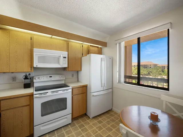 a kitchen with a stove a sink and a refrigerator
