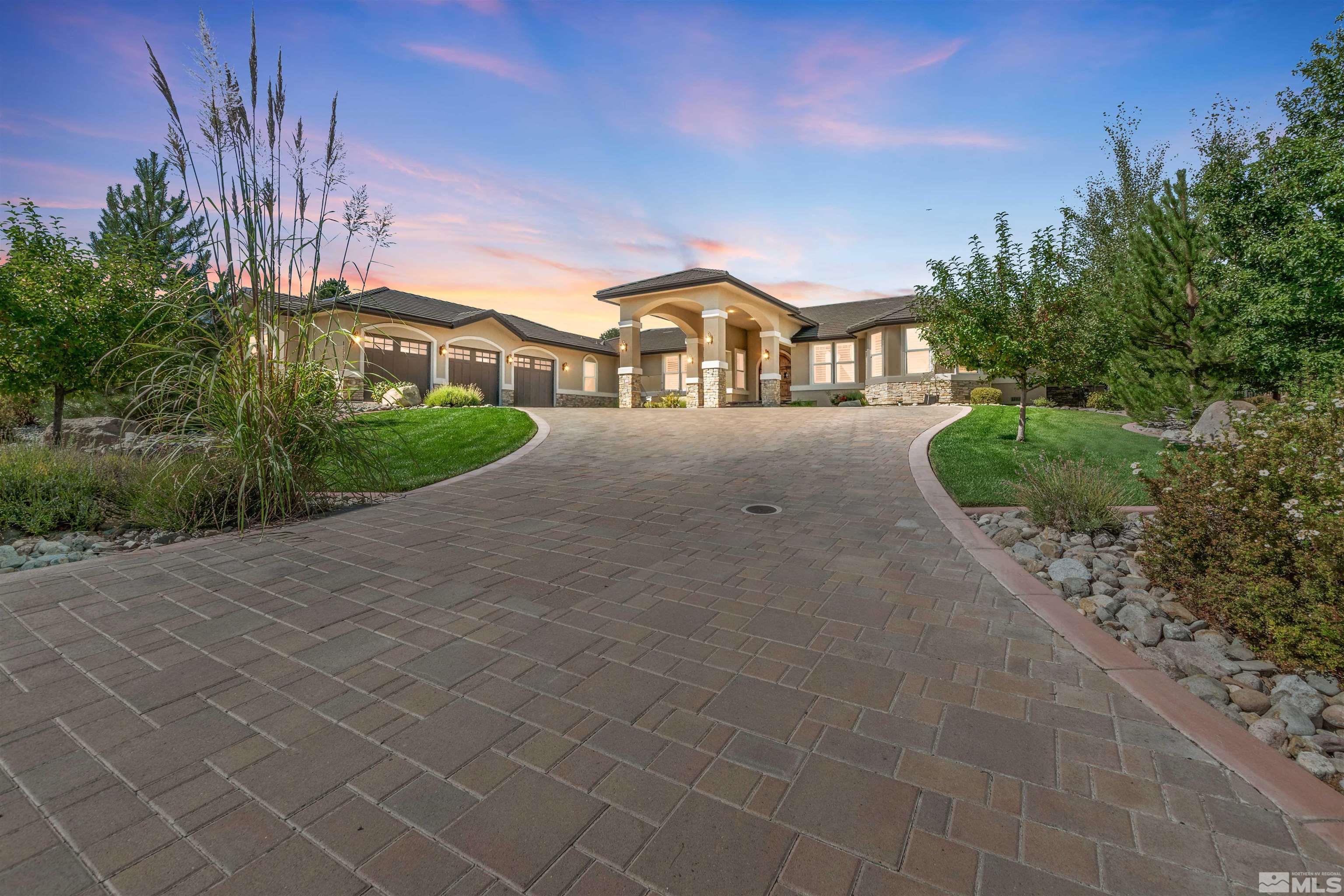12825 Silver Wolf Road Reno, NV 89511 - Photo 1 of 34 a front view of a house with a yard and garage