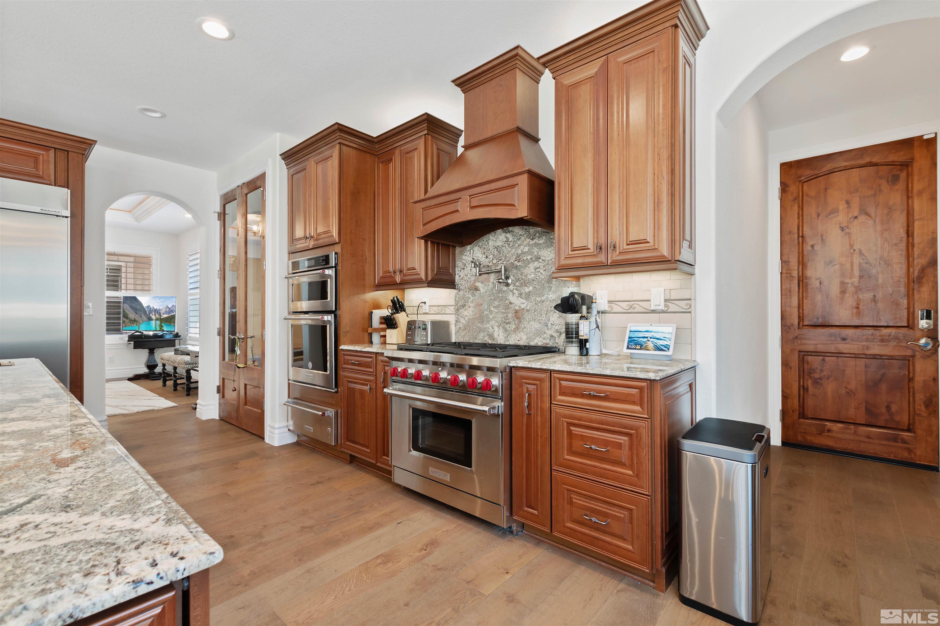 12825 Silver Wolf Road Reno, NV 89511 - Photo 14 of 34 a kitchen with stainless steel appliances granite countertop a refrigerator a stove and a sink